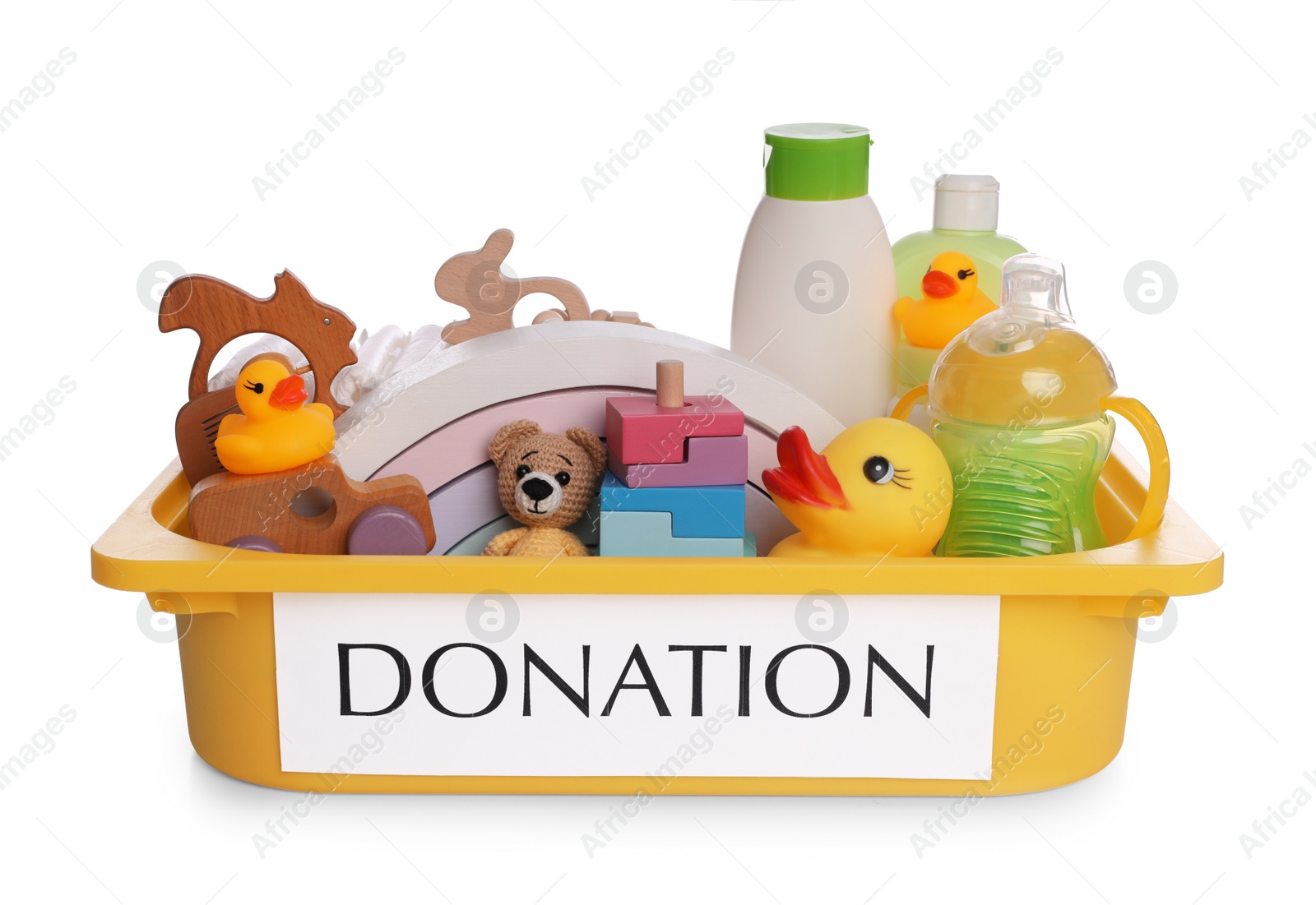 Photo of Donation box full of different toys and baby accessories isolated on white