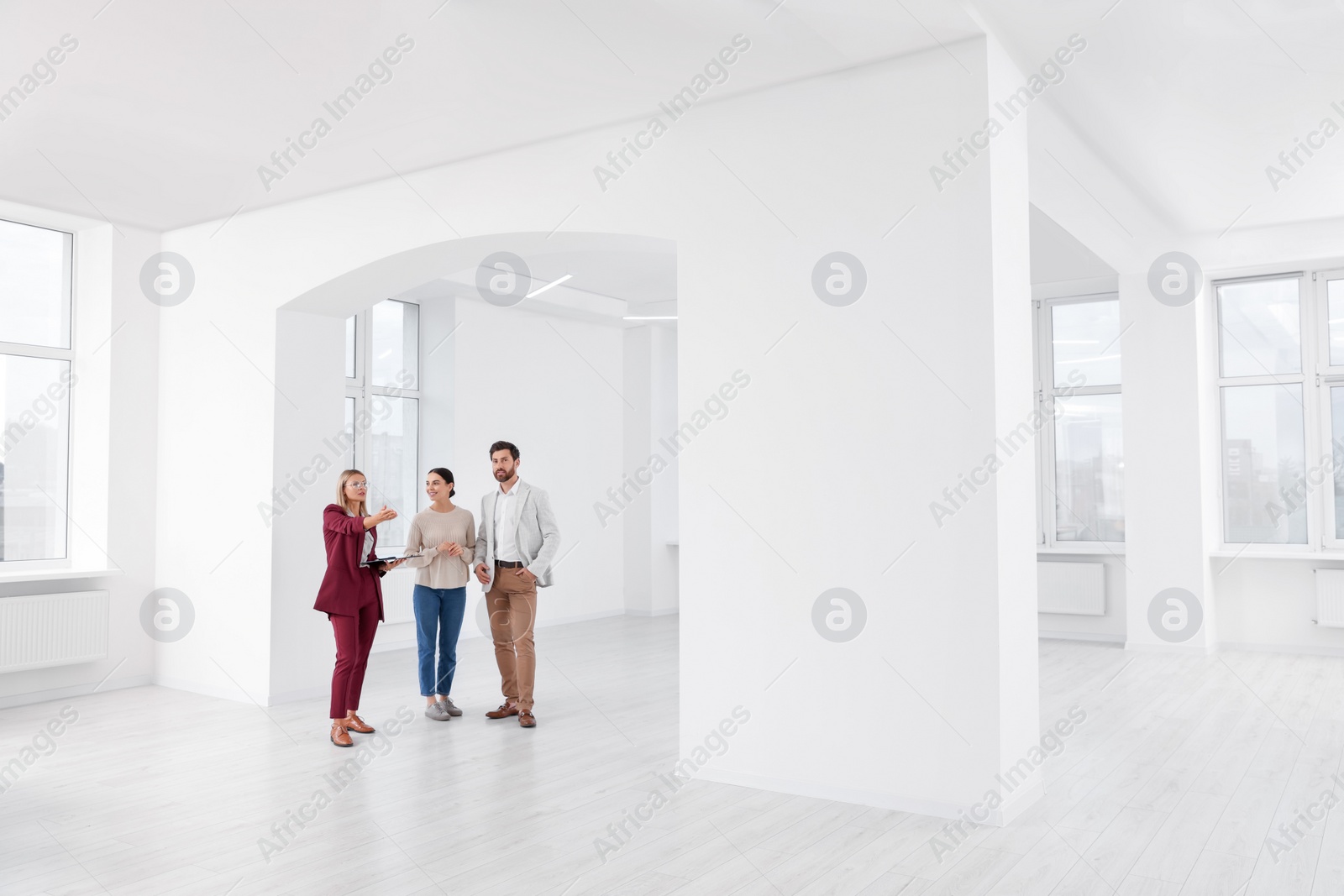 Photo of Real estate agent showing new apartment to couple