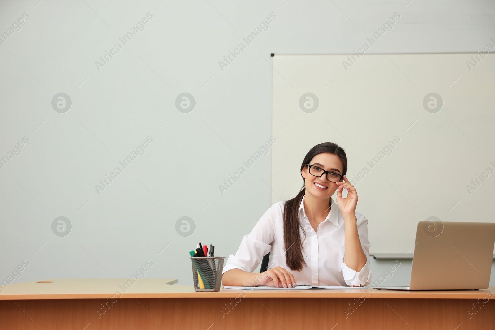 Photo of Female teacher at her desk in classroom