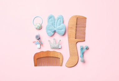 Flat lay composition with wooden hair combs on pink background