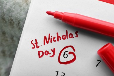 Photo of Saint Nicholas Day. Calendar with marked date December 06 and marker, top view