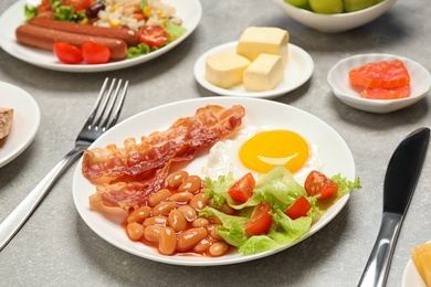 Photo of Plate with delicious food on light grey table, closeup. Buffet service