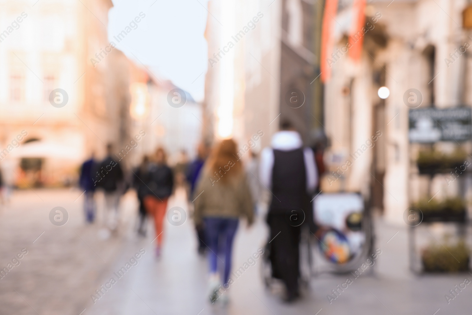 Photo of Blurred view of people walking on city street