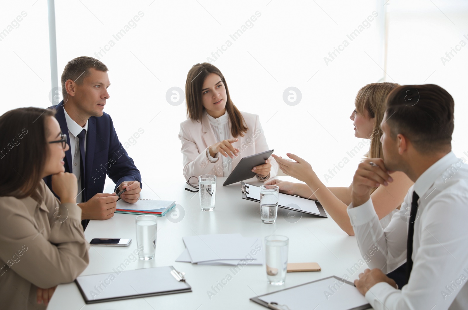 Photo of Office employees talking at table during meeting