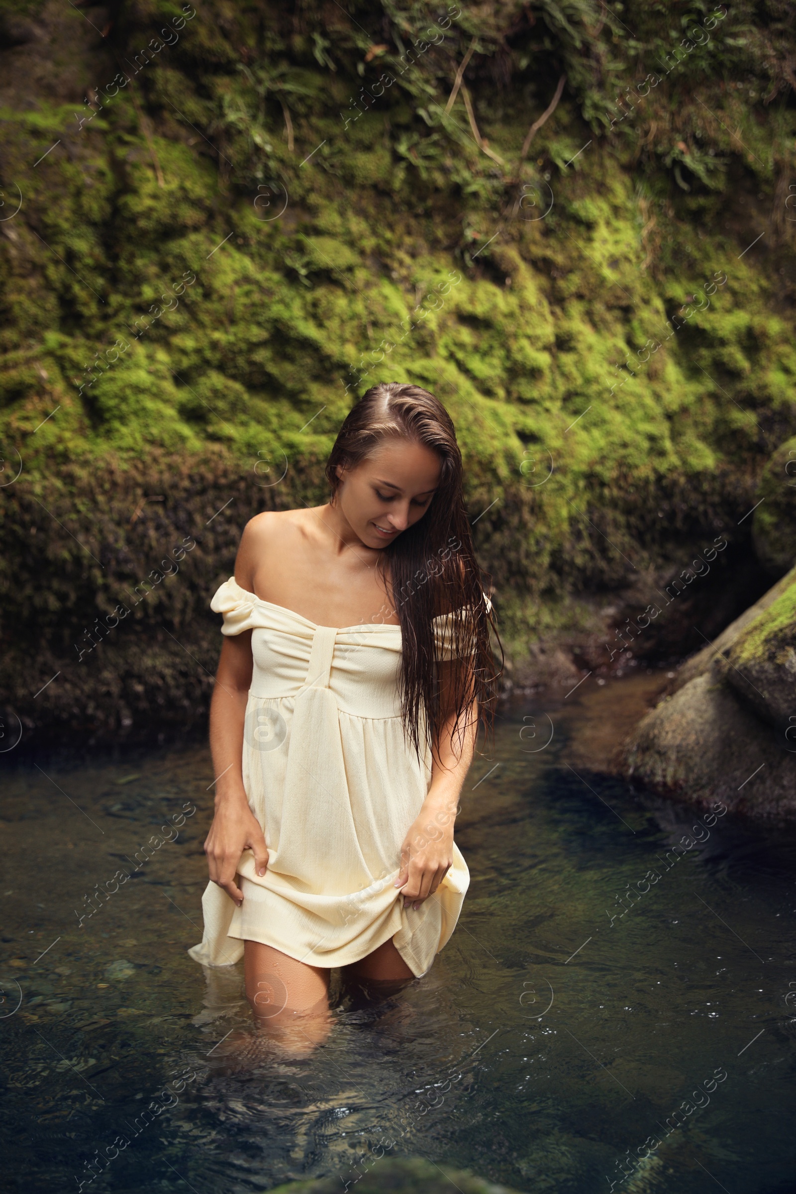 Photo of Beautiful young woman in mountain river outdoors