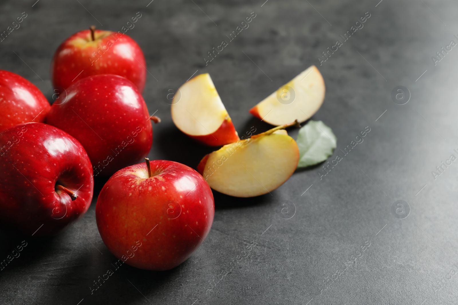 Photo of Fresh ripe red apples on grey background