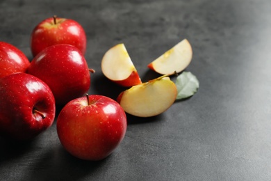 Fresh ripe red apples on grey background