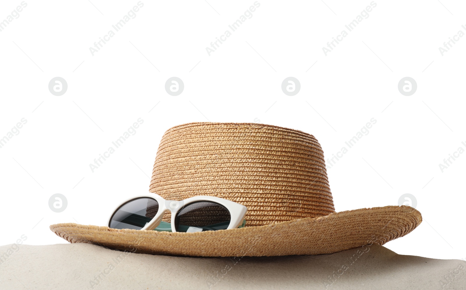 Photo of Hat and sunglasses on sand against white background. Stylish beach accessories