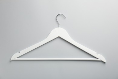 Photo of White hanger on light gray background, top view