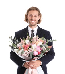 Young handsome man in stylish suit with beautiful flower bouquet on white background