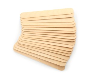 Disposable wooden spatulas for depilatory wax on white background, top view