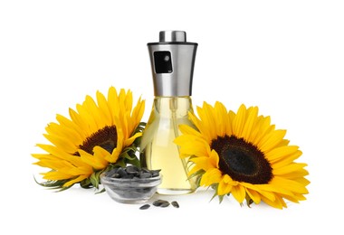 Photo of Spray bottle with cooking oil, sunflowers and seeds on white background