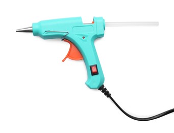 Photo of Turquoise glue gun with stick isolated on white, top view