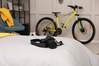 Photo of Modern camera on bed in stylish teenager's room interior