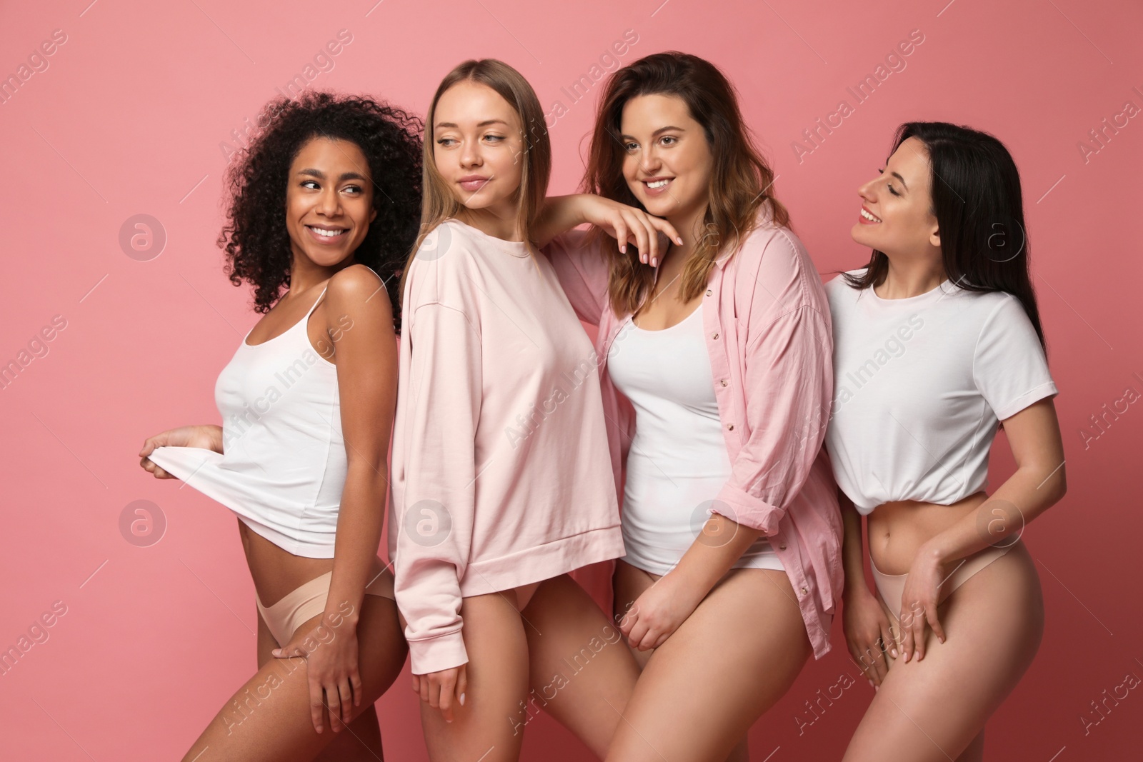 Photo of Group of women with different body types in underwear on pink background