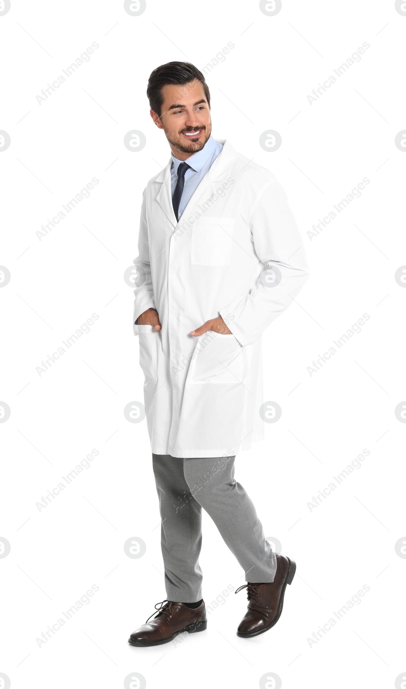 Photo of Young male doctor walking on white background. Medical service