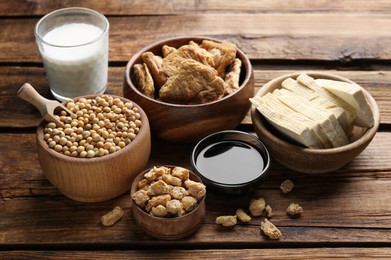 Photo of Different natural soy products on wooden table