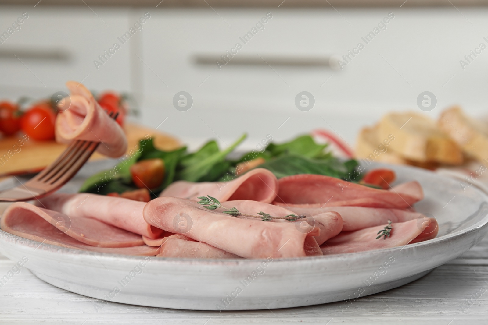 Photo of Tasty ham on white wooden table, closeup