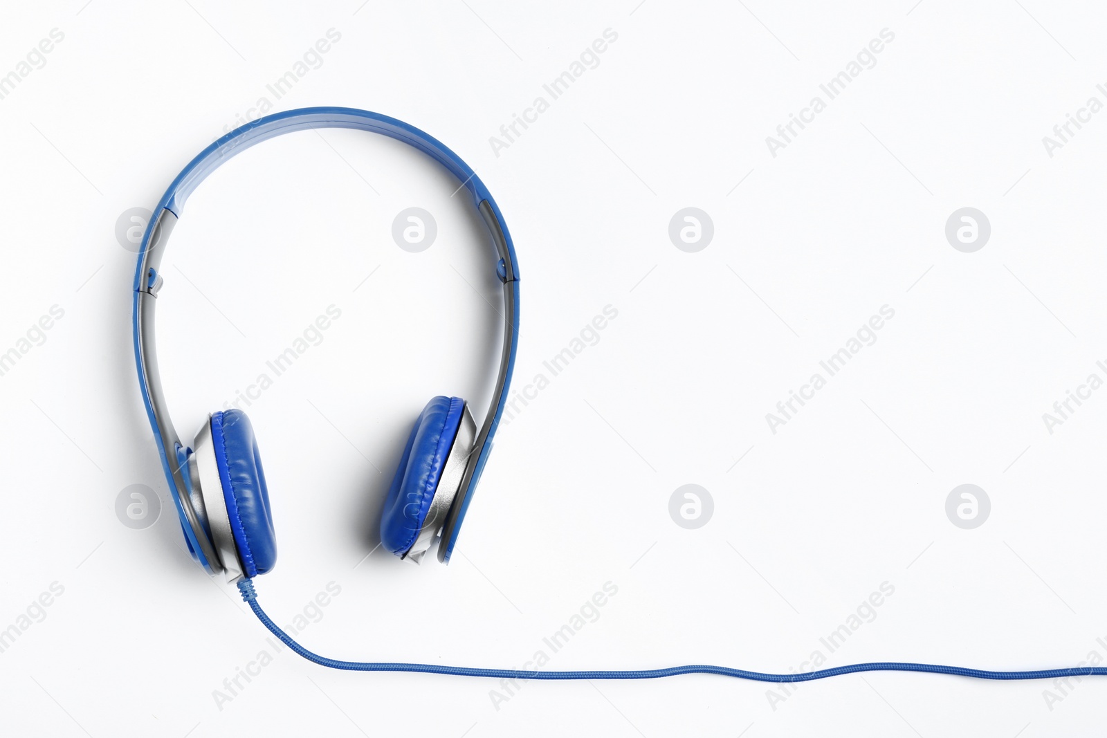 Photo of Stylish modern headphones on white background, top view