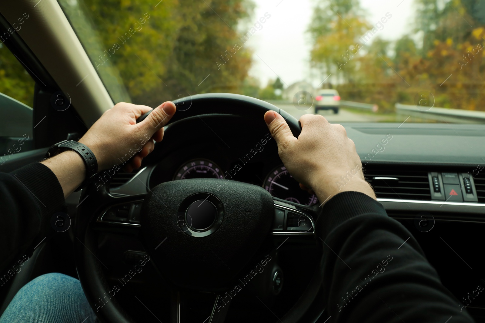 Photo of Man driving his car, closeup. Traffic rules