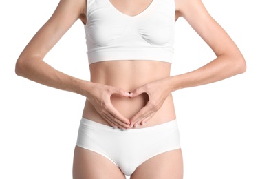 Young woman holding hands in heart shape on white background. Gynecology concept