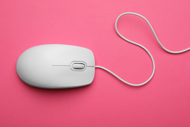 Photo of Wired computer mouse on pink background, top view