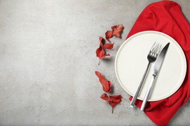 Setting with beautiful cutlery on textured table, top view. Space for text