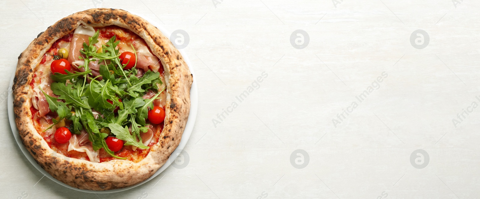 Photo of Tasty pizza with meat and arugula on white table, top view. Space for text