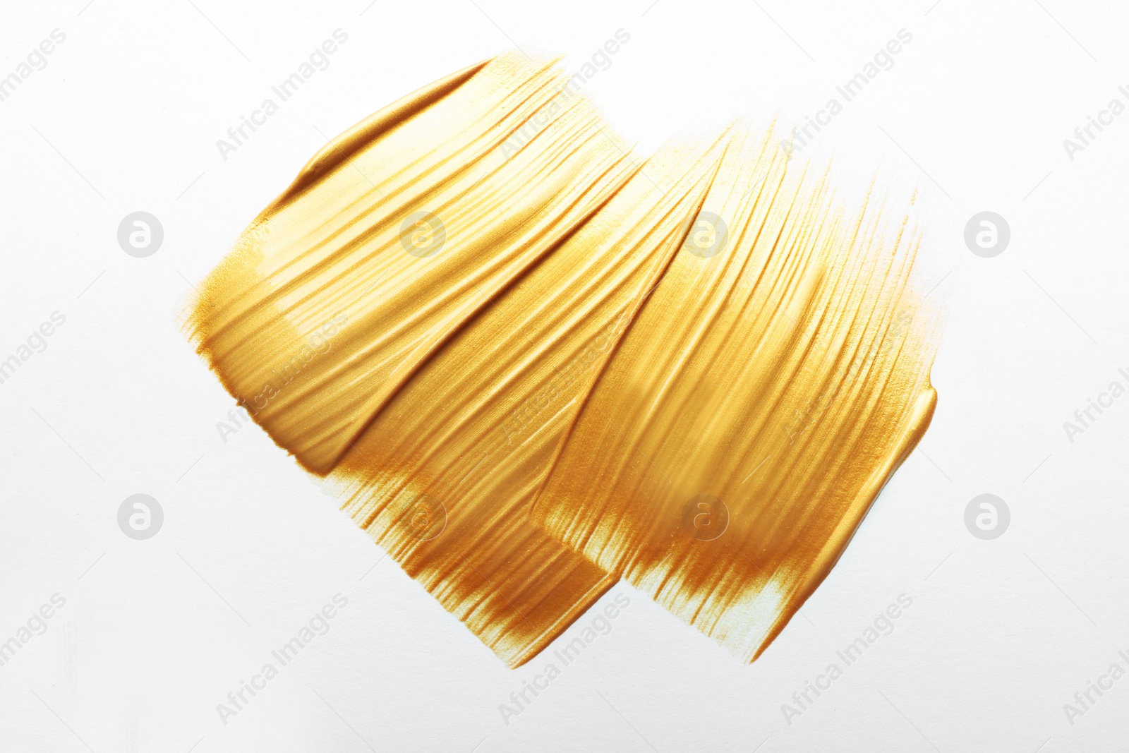 Photo of Strokes of gold paint isolated on white, top view