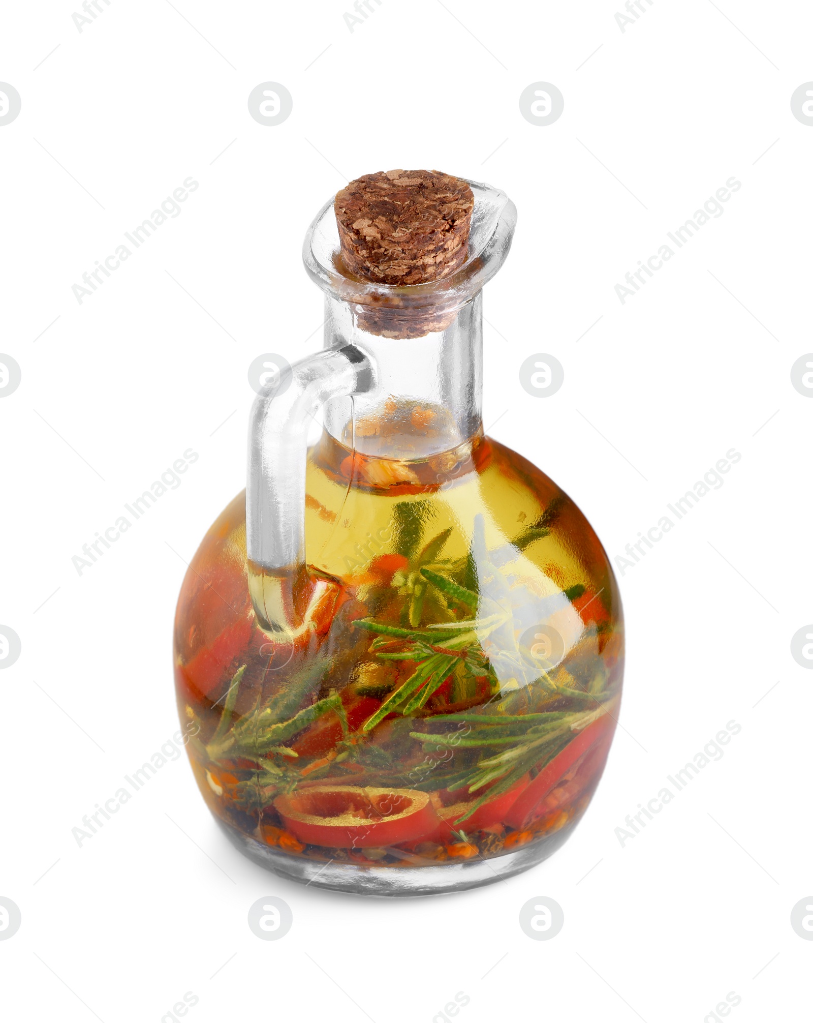 Photo of Glass jug of cooking oil with spices and herbs isolated on white