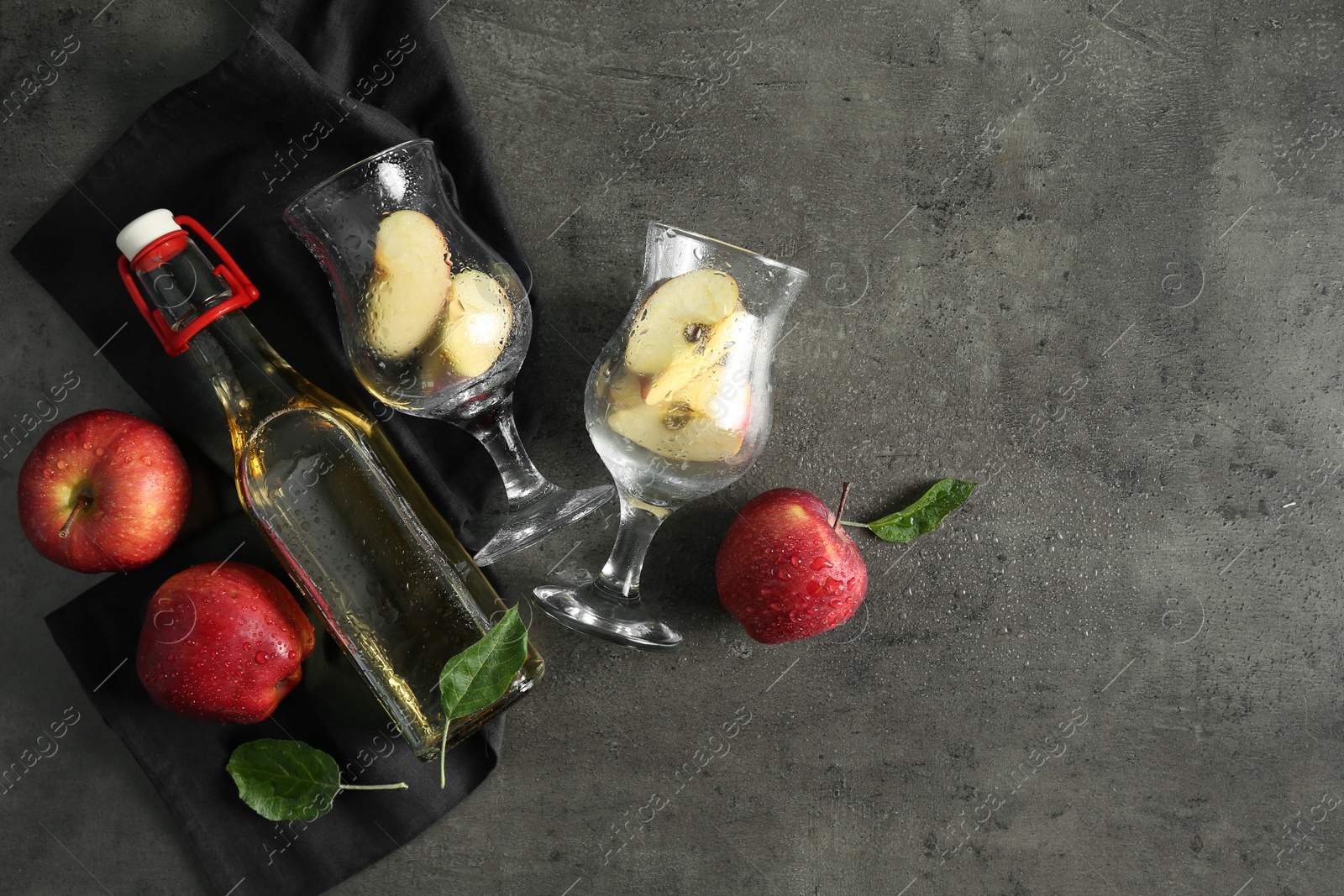 Photo of Flat lay composition with delicious apple cider on gray table, space for text