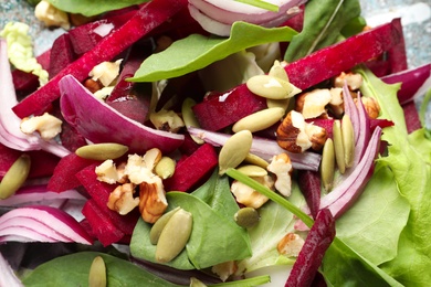 Photo of Delicious salad with beet as background, closeup