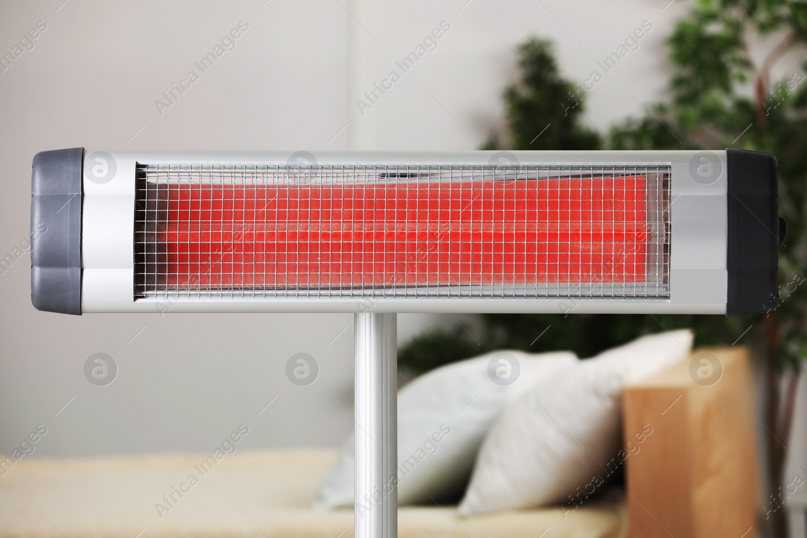 Photo of Modern electric infrared heater in cozy room