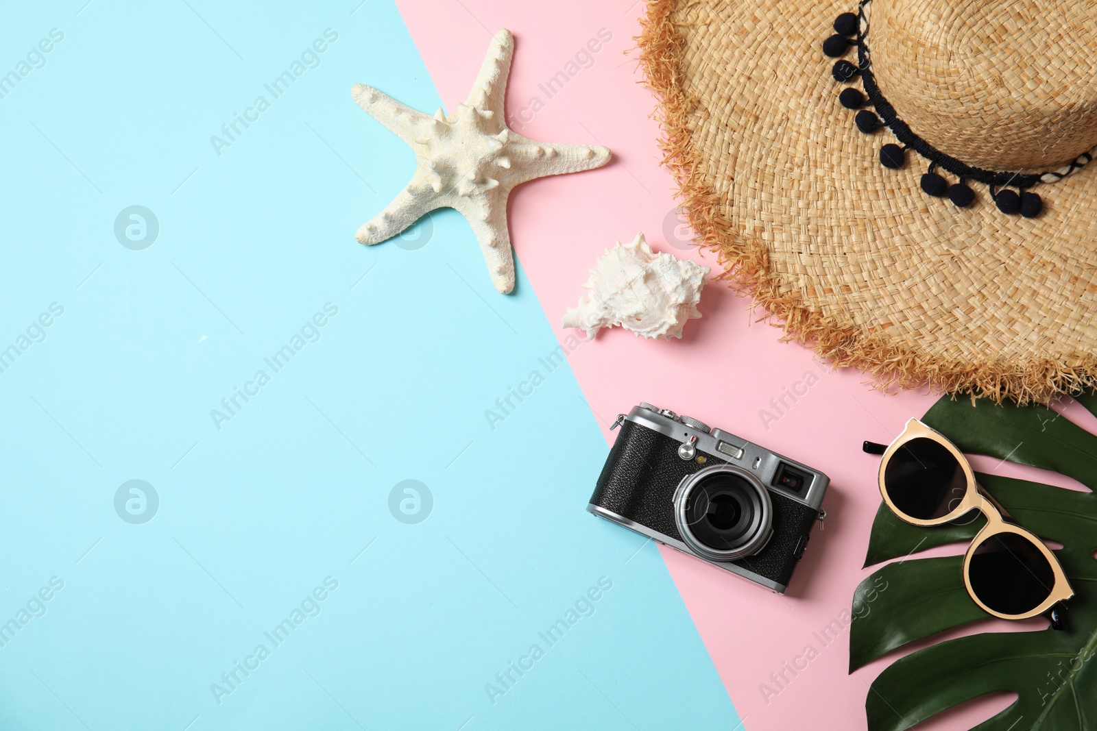 Photo of Flat lay composition with summer accessories, camera and space for text on color background. Travel blogger