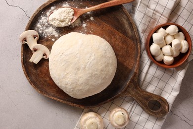 Photo of Pizza dough and products on gray textured table, flat lay