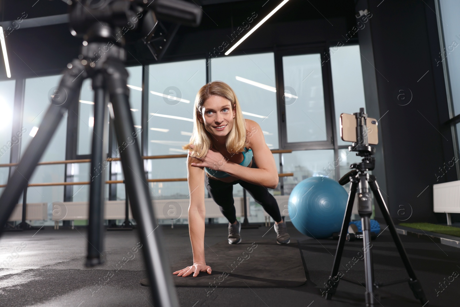 Photo of Fitness trainer recording online classes in gym