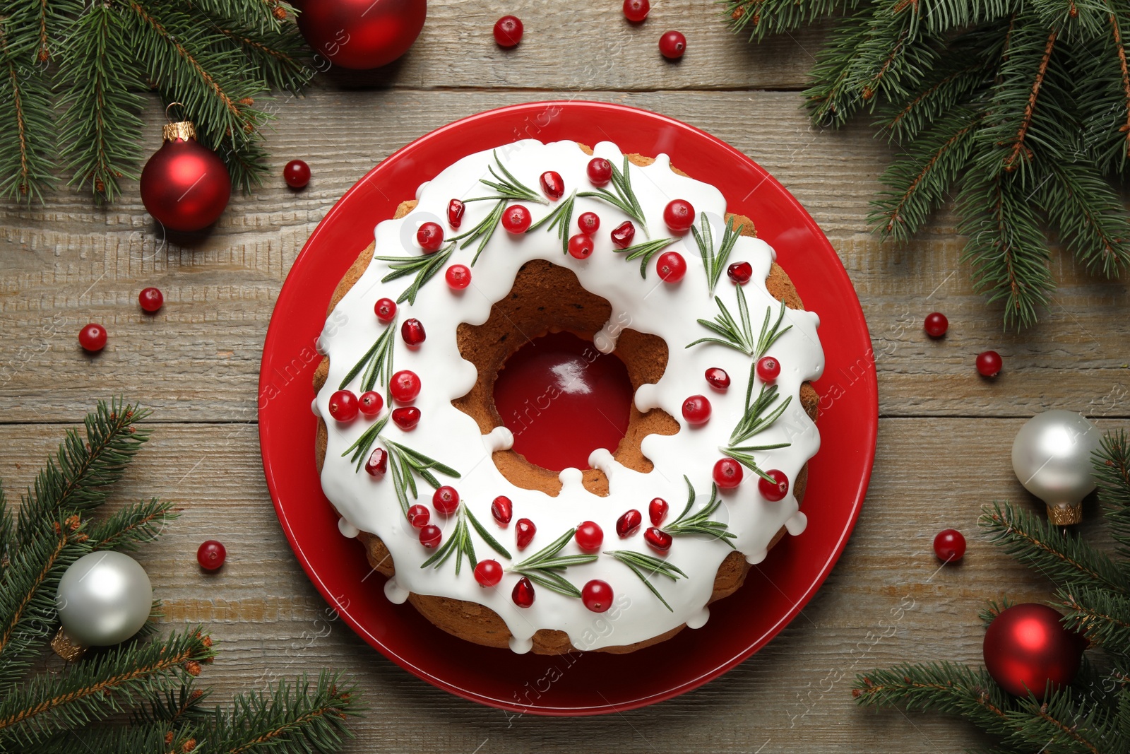 Photo of Flat lay composition with traditional Christmas cake and decorations on wooden table