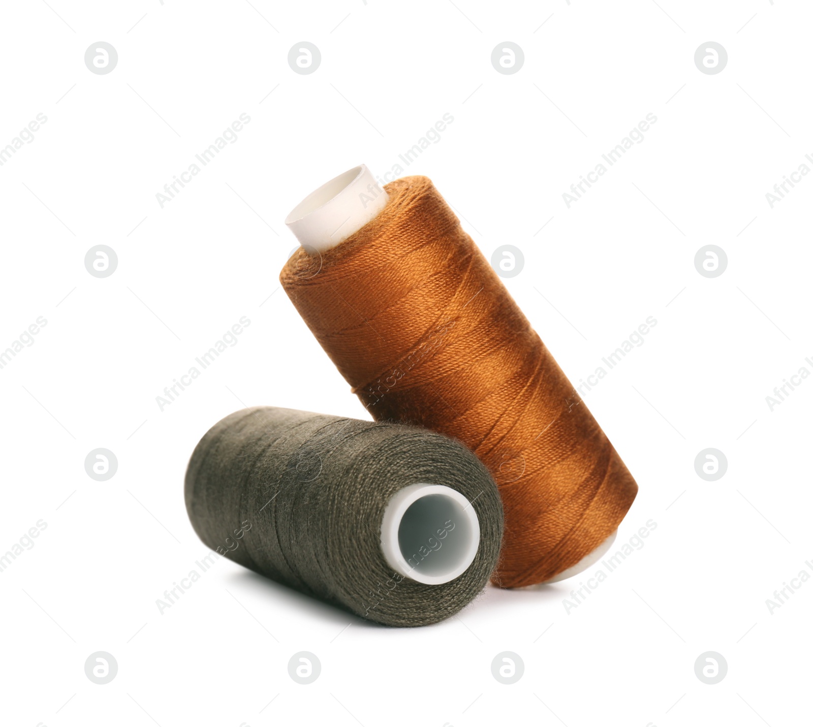 Photo of Different colorful sewing threads on white background