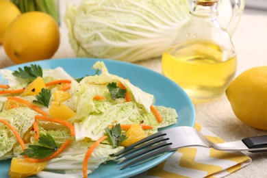 Photo of Tasty salad with Chinese cabbage, products and fork on table, closeup