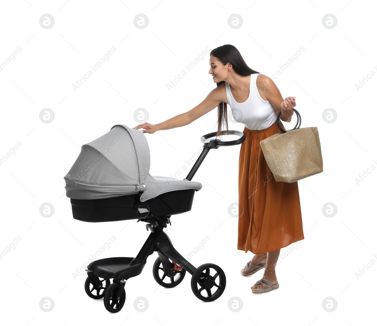 Photo of Happy young woman with baby stroller on white background