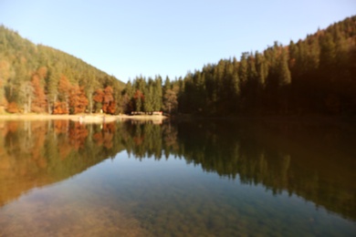 Photo of Beautiful mountain landscape with forest near water, blurred view