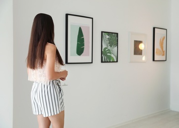 Young woman at exhibition in art gallery