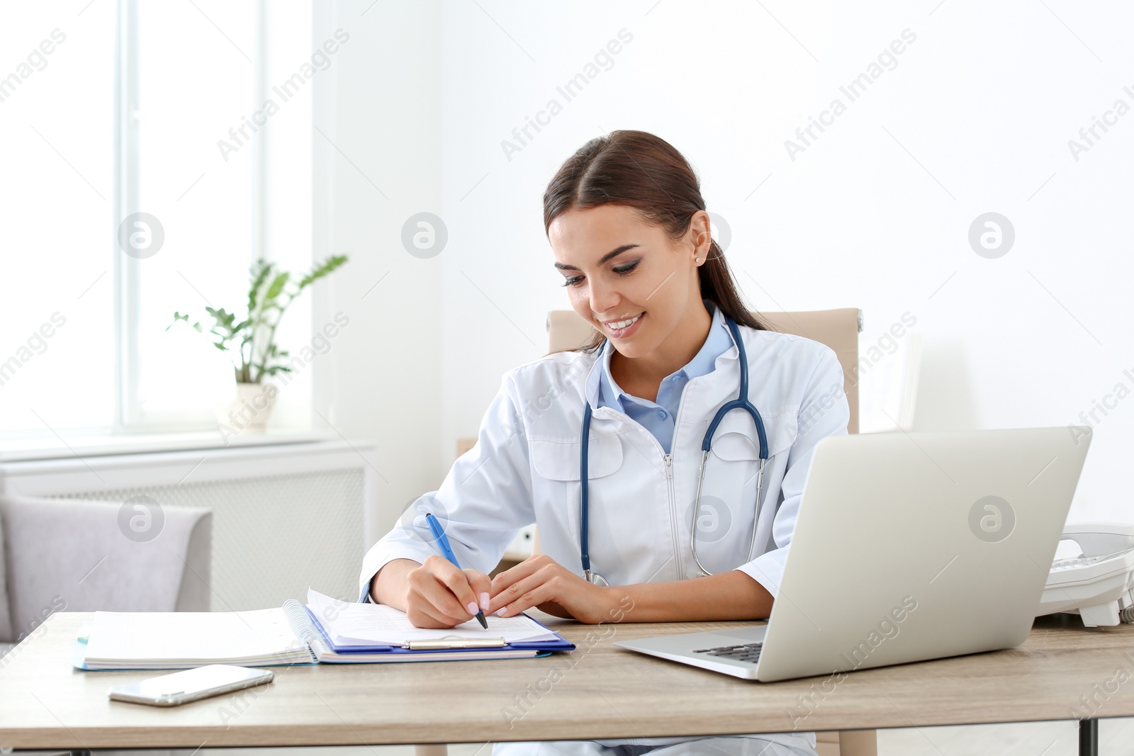 Photo of Female medical assistant at workplace in clinic. Health care service