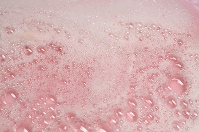 Colorful foam after dissolving bath bomb in water, closeup