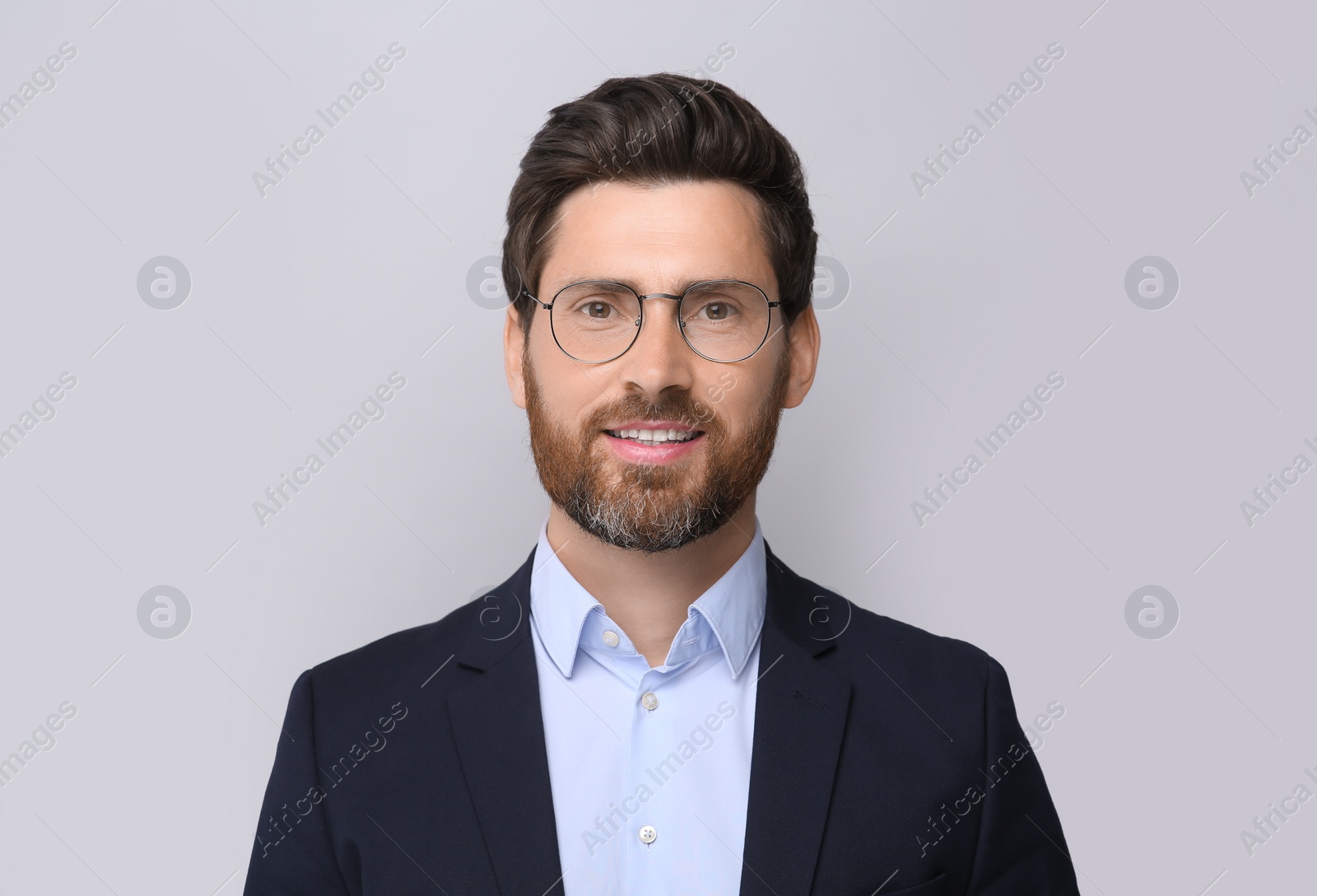 Photo of Portrait of handsome man in glasses on light grey background