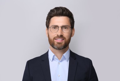 Photo of Portrait of handsome man in glasses on light grey background