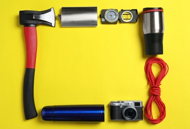 Photo of Frame of traveler's equipment on yellow background, flat lay. Space for text