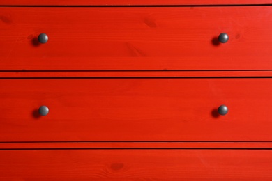 Photo of Red wardrobe drawers as background, closeup view