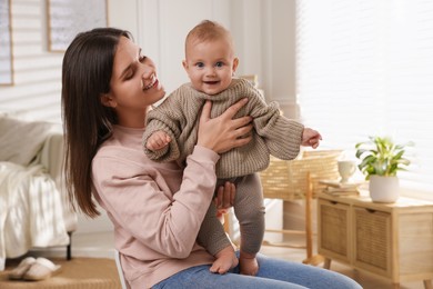 Photo of Happy young mother with her baby at home