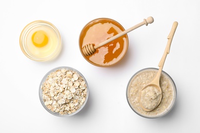 Photo of Composition of handmade face mask and ingredients on white background, top view